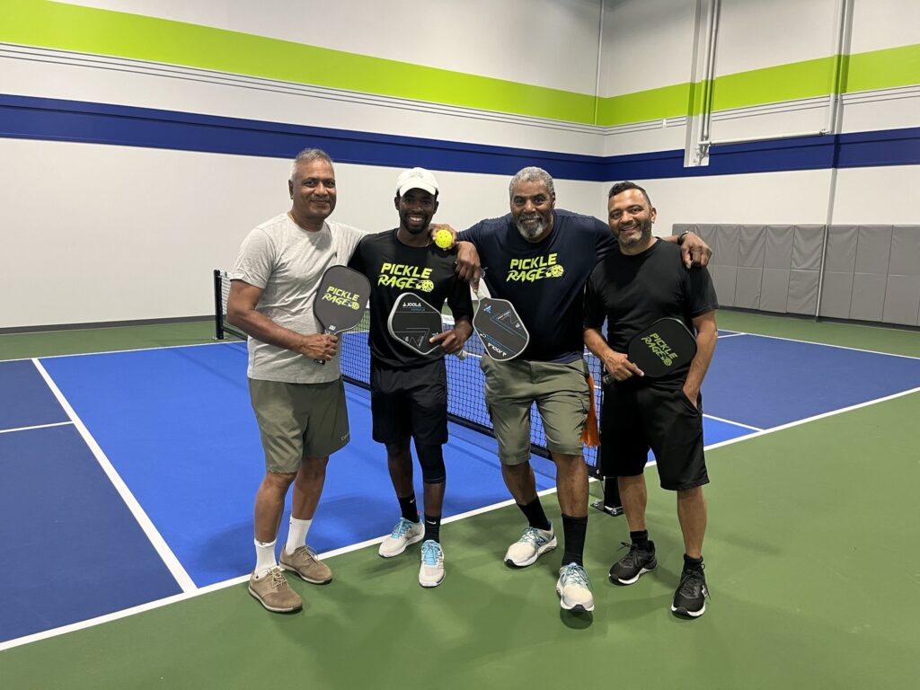 4 men playing Pickleball